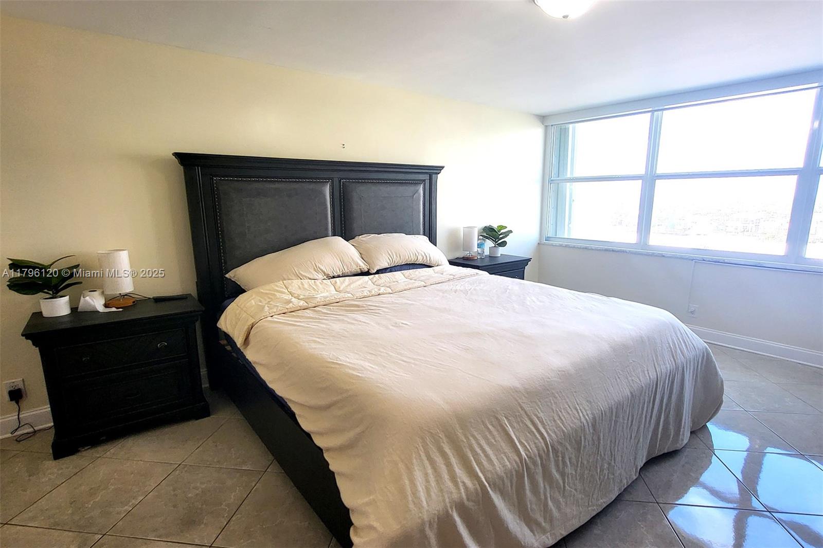 2101 South Ocean Drive, Unit 606 Hollywood, FL 33019 - Photo 16 of 58 a bedroom with a bed and a window