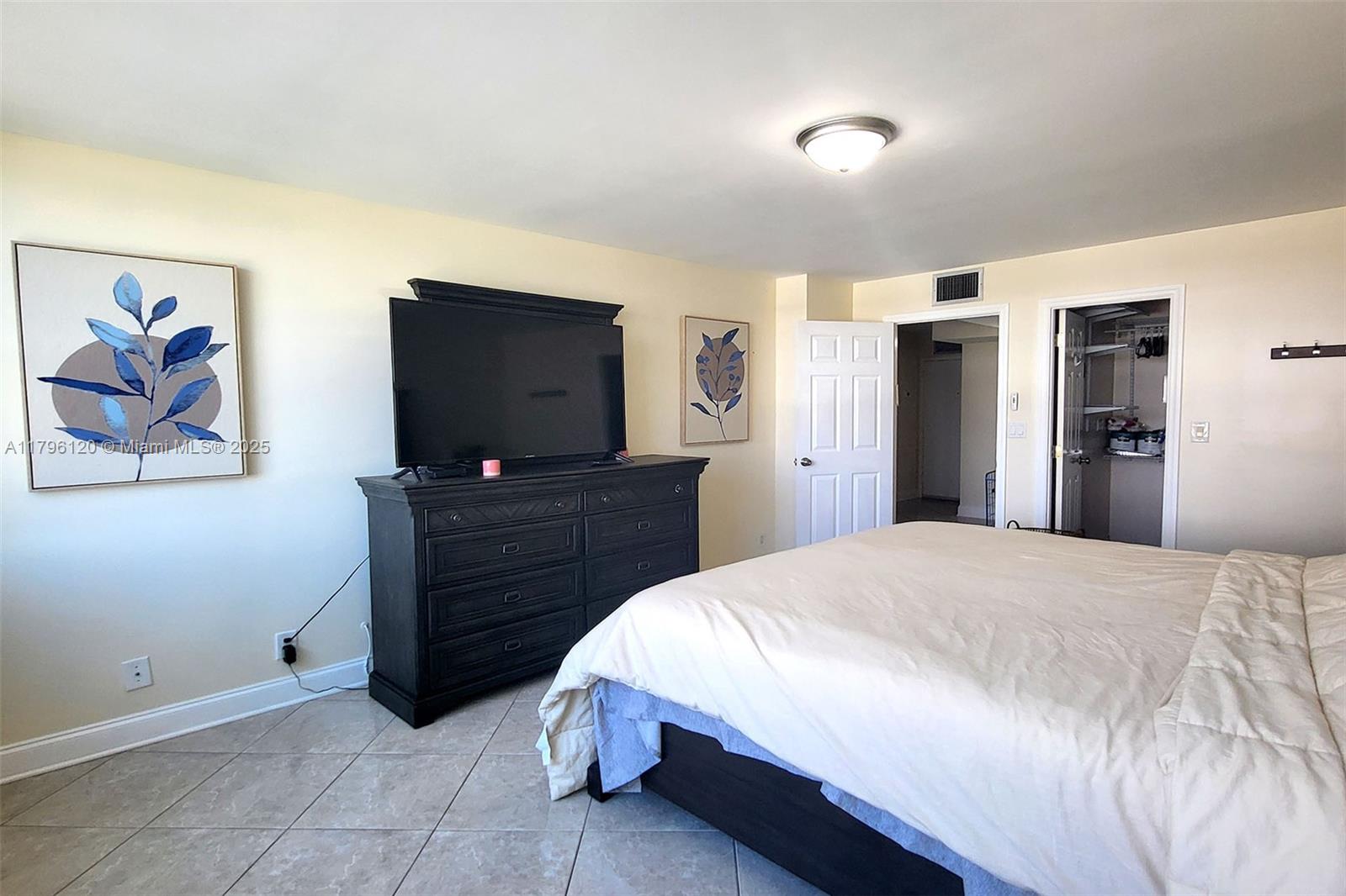 2101 South Ocean Drive, Unit 606 Hollywood, FL 33019 - Photo 18 of 58 a bed room with a bed and a television