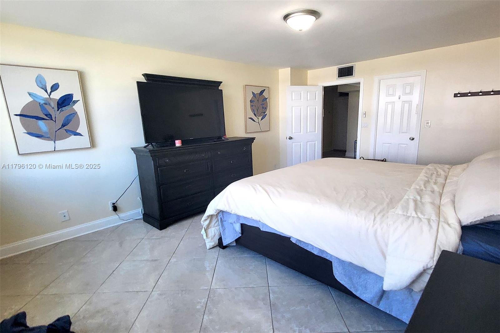 2101 South Ocean Drive, Unit 606 Hollywood, FL 33019 - Photo 20 of 58 a bedroom with a bed and a flat screen tv