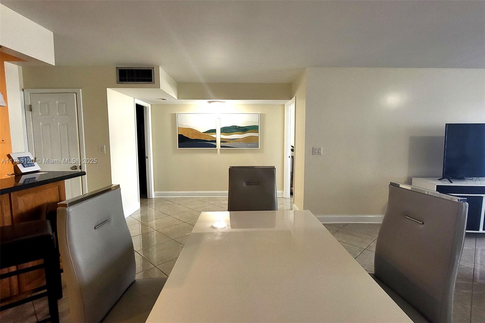 2101 South Ocean Drive, Unit 606 Hollywood, FL 33019 - Photo 5 of 58 a view of a living room with a flat screen tv