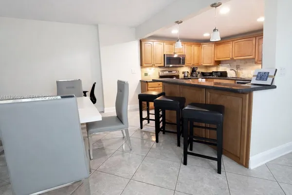 a kitchen with cabinets stainless steel appliances and a window