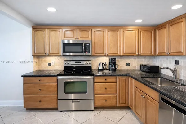 a view of a room with a window and furniture