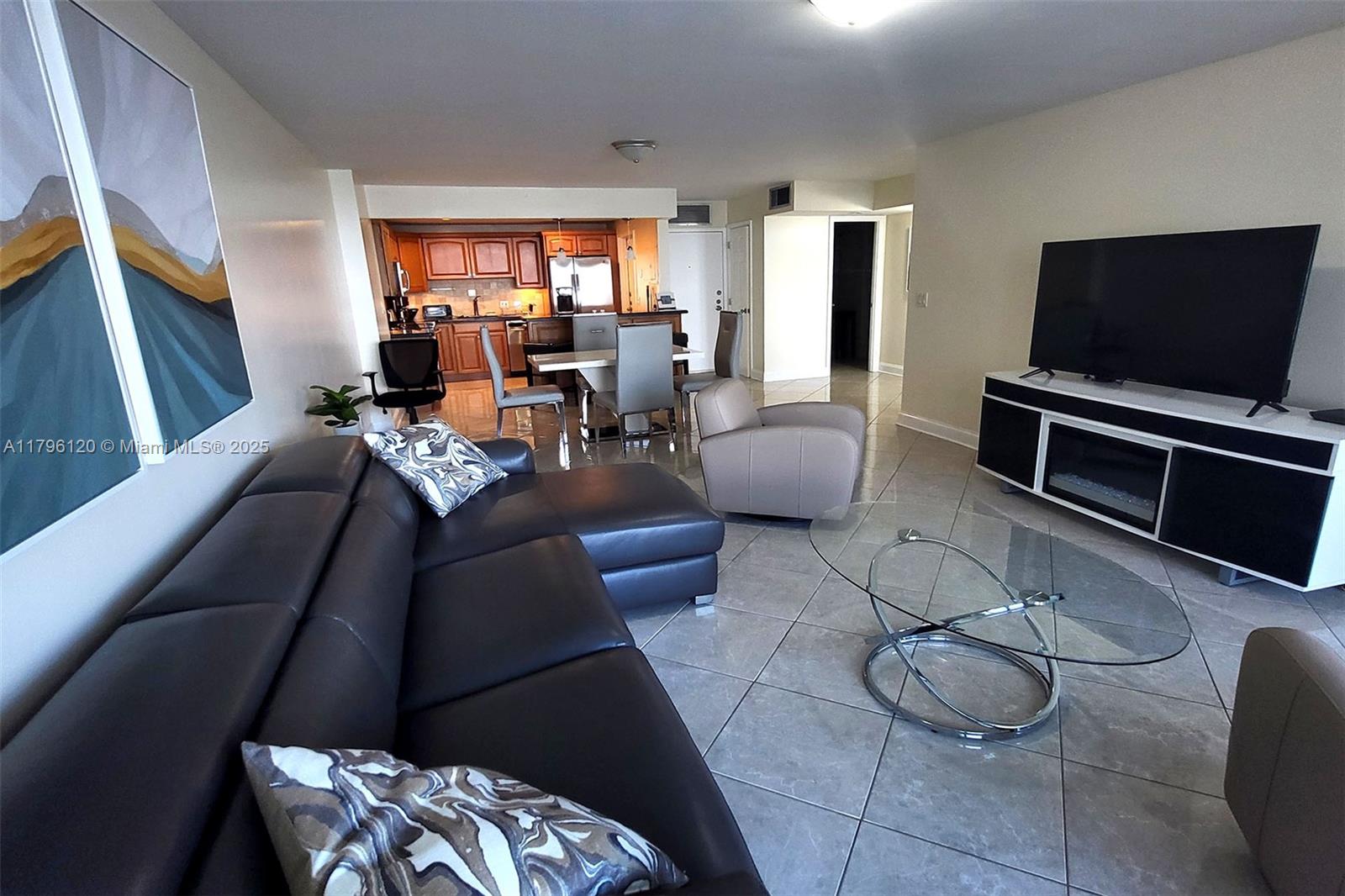 2101 South Ocean Drive, Unit 606 Hollywood, FL 33019 - Photo 8 of 58 a living room with furniture and a flat screen tv