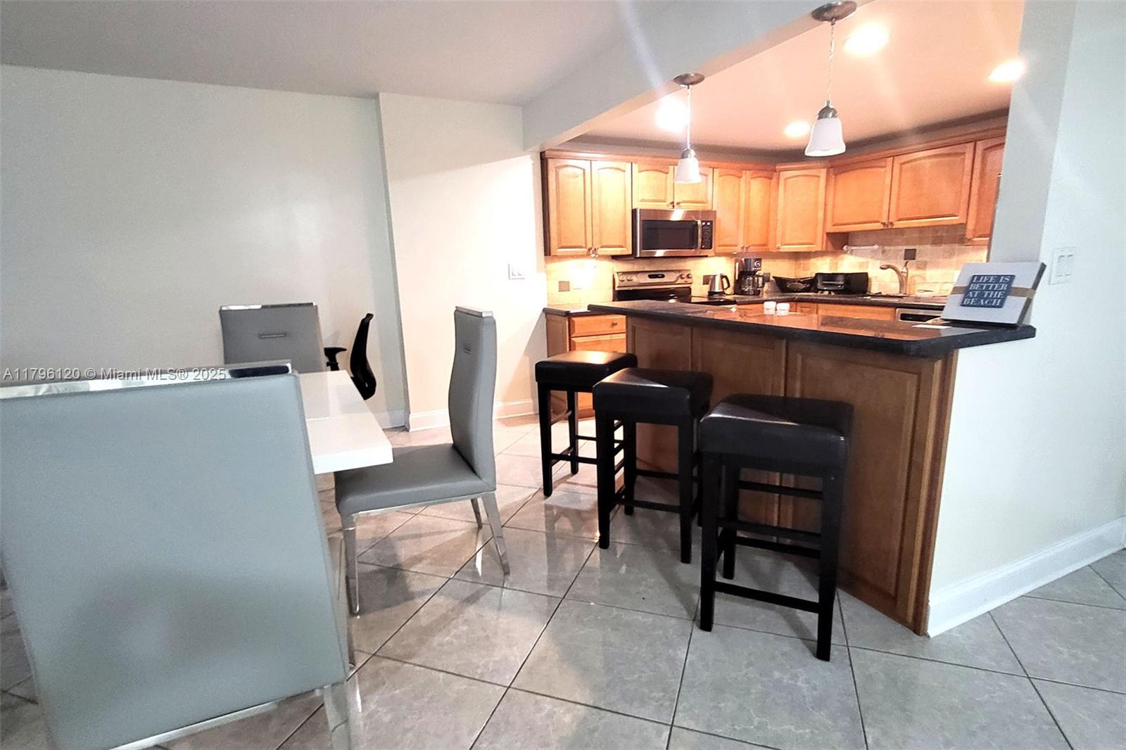 2101 South Ocean Drive, Unit 606 Hollywood, FL 33019 - Photo 9 of 58 a kitchen with a sink a counter top space and appliances