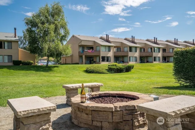 a view of a house with a yard and sitting area