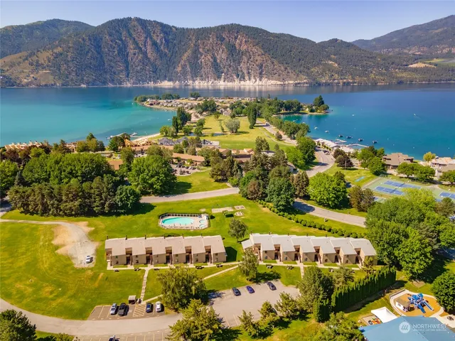 aerial view of a house with a garden and lake view