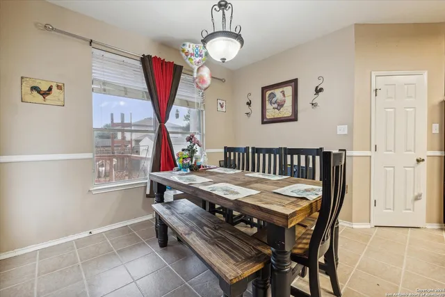 a kitchen with stainless steel appliances granite countertop a stove a refrigerator a microwave oven a sink and a dining table with garden view