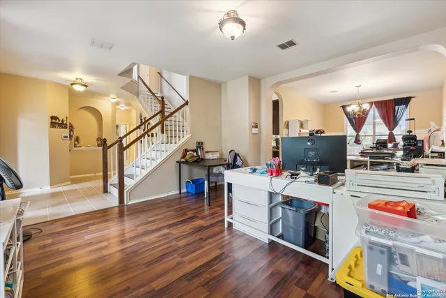 a view of a workspace with wooden floor and a window