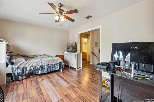 a bedroom with furniture a rug toys and a window