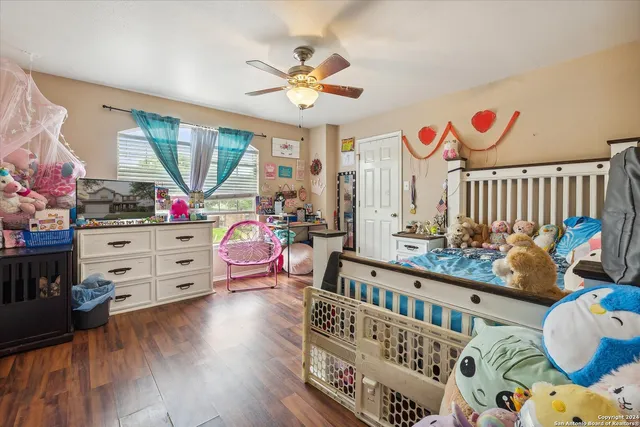 a bedroom with furniture and wooden floor
