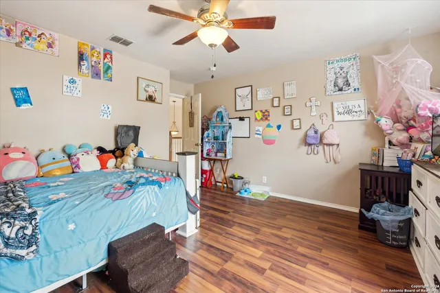 a view of a hallway with wooden floor and windows