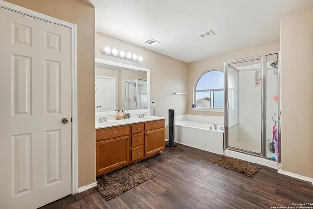 a view of a kitchen cabinets a sink and wooden floor