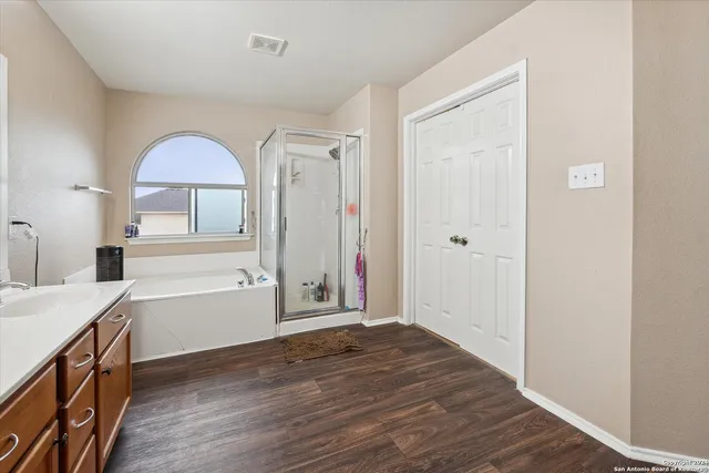 a bathroom with a double vanity sink and mirror