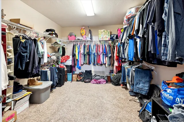 a view of a house with a patio and a yard