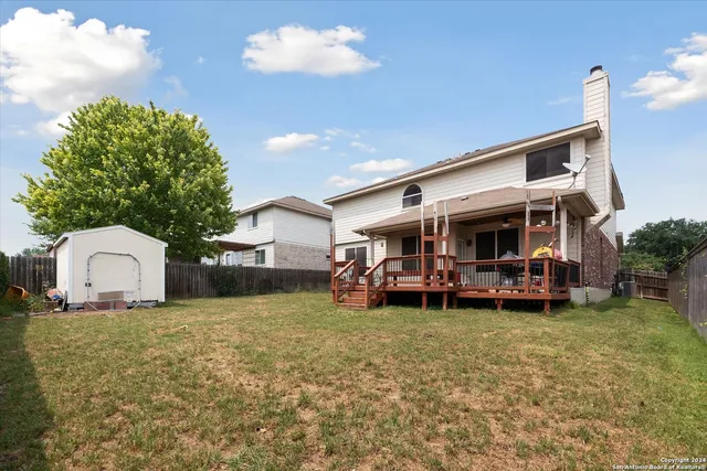 a view of a house with a yard and sitting area