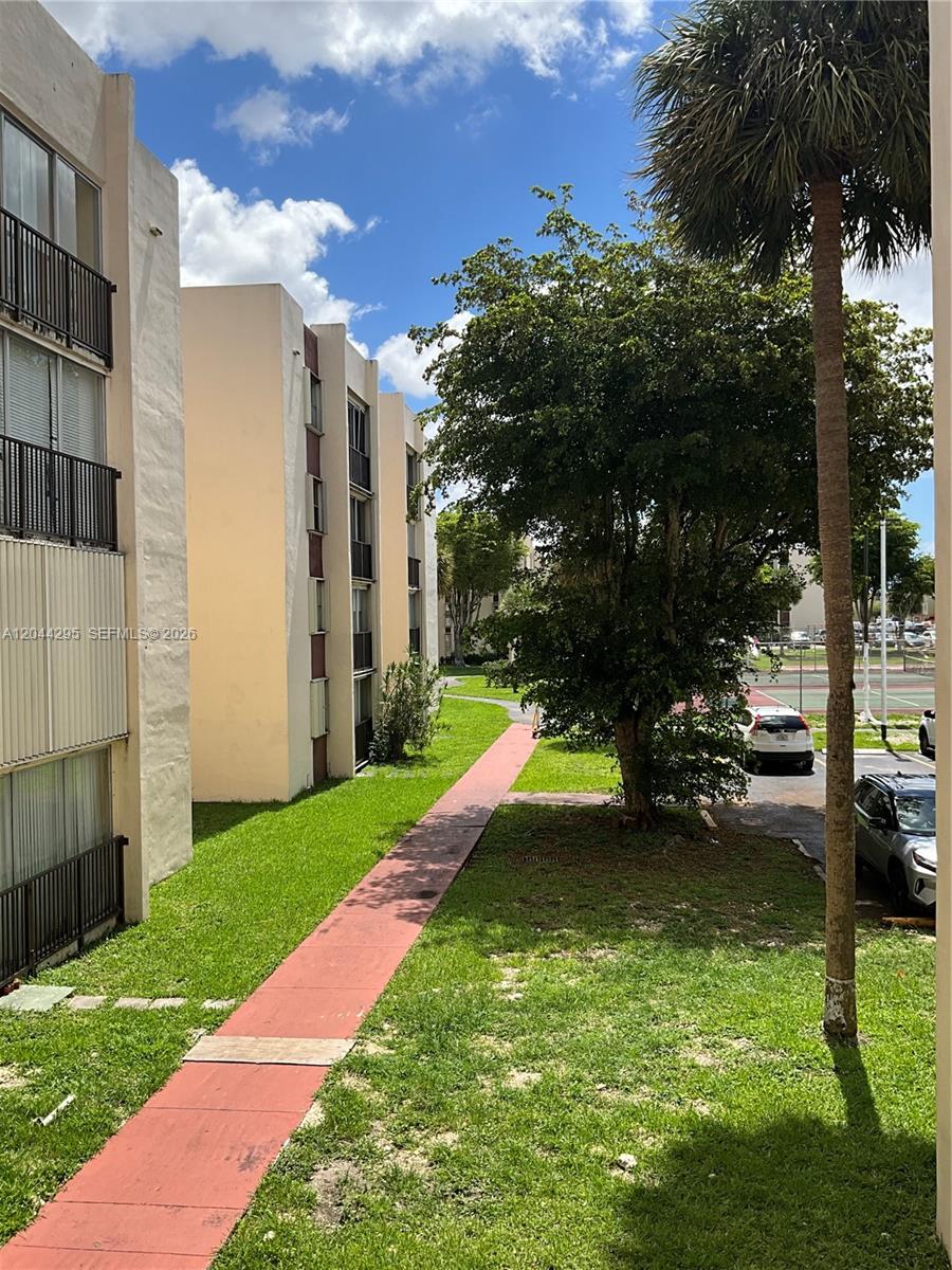 9441 Southwest 4th Street, Unit 214 Miami, FL 33174 - Photo 22 of 22 a view of a house with a yard