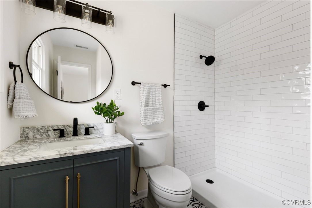 1700 Globe Road Aylett, VA 23009 - Photo 15 of 24 a bathroom with a granite countertop sink a toilet and shower