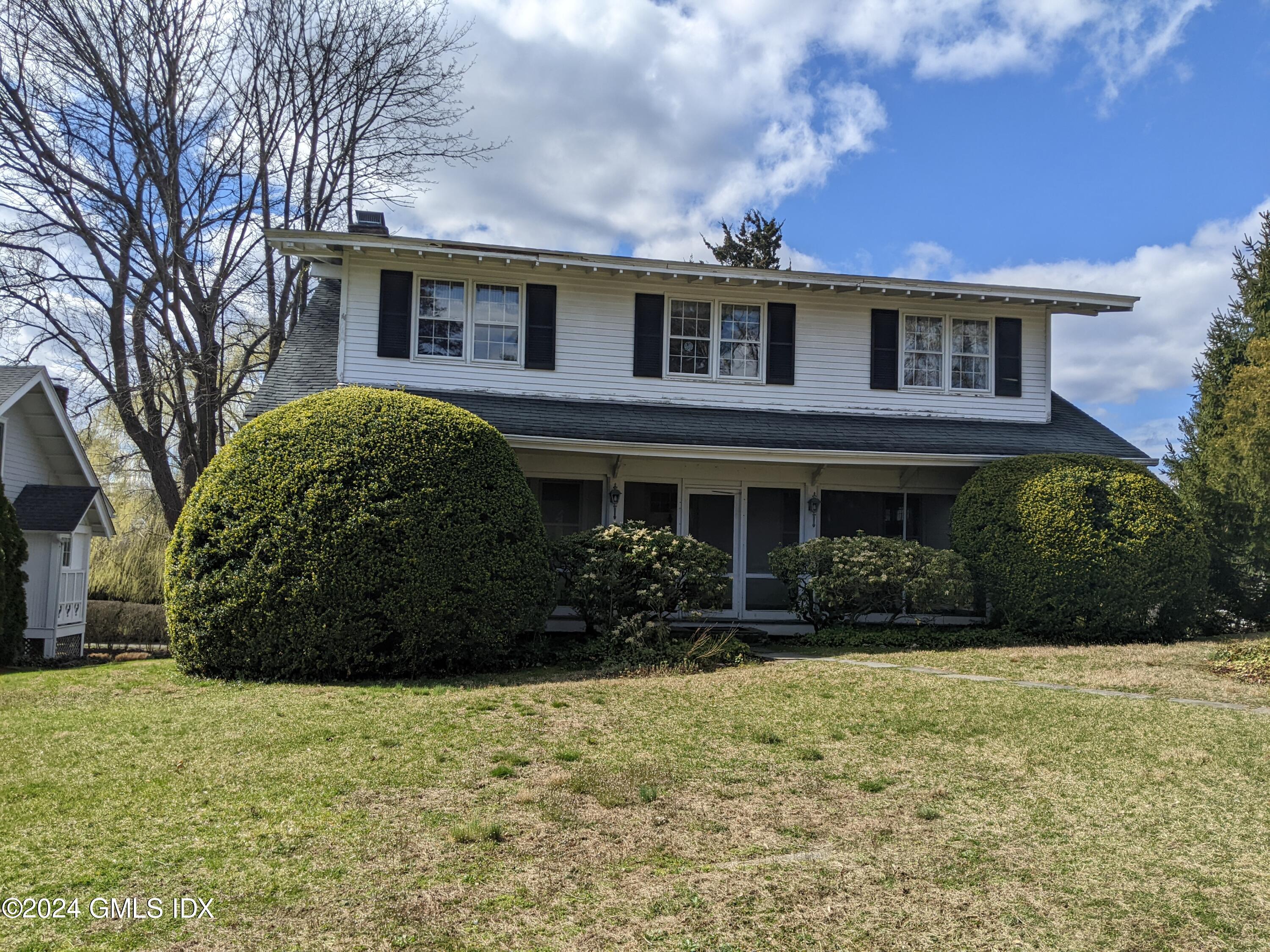 23 Ballwood Road Old Greenwich, CT 06870 - Photo 1 of 27 a front view of a house with garden
