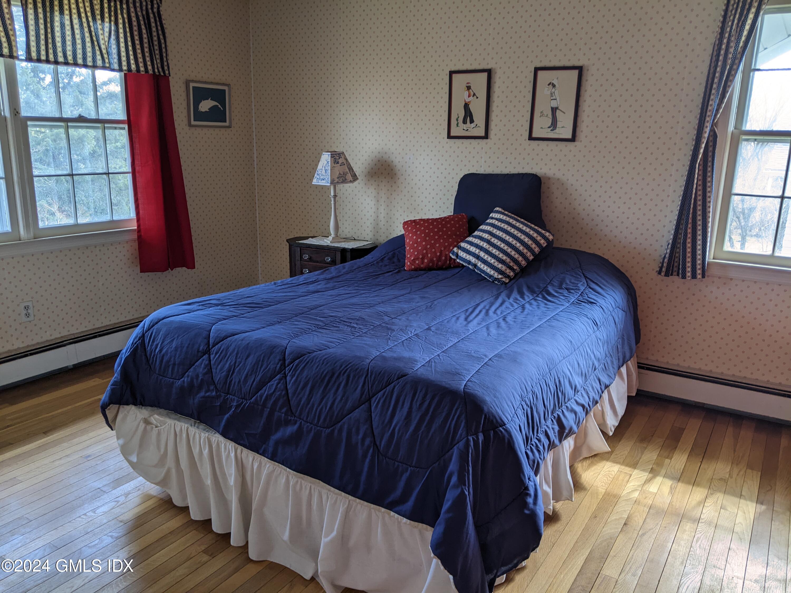 23 Ballwood Road Old Greenwich, CT 06870 - Photo 16 of 27 a bedroom with a bed and wooden floor