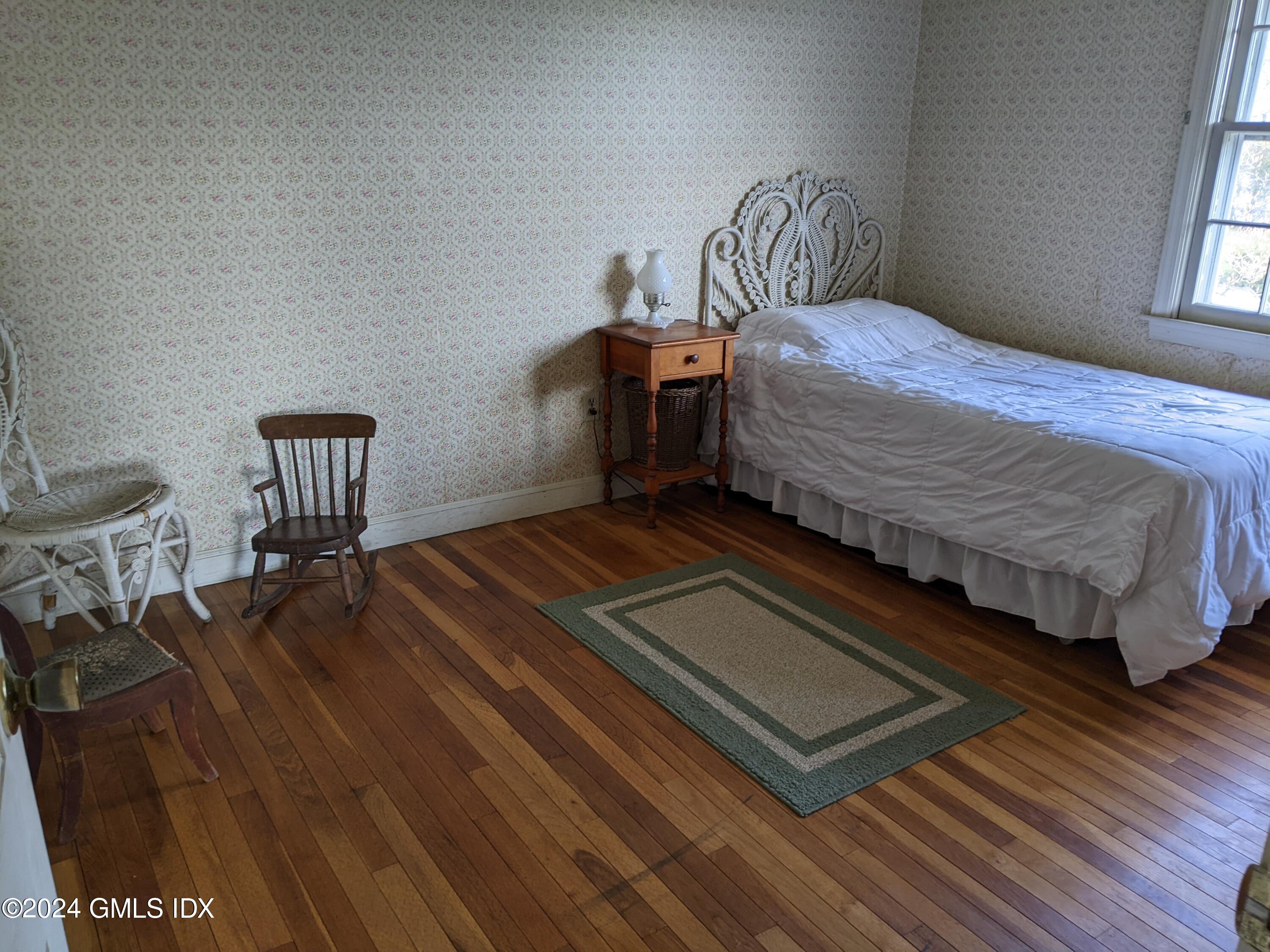 23 Ballwood Road Old Greenwich, CT 06870 - Photo 18 of 27 a bedroom with a bed and wooden floor