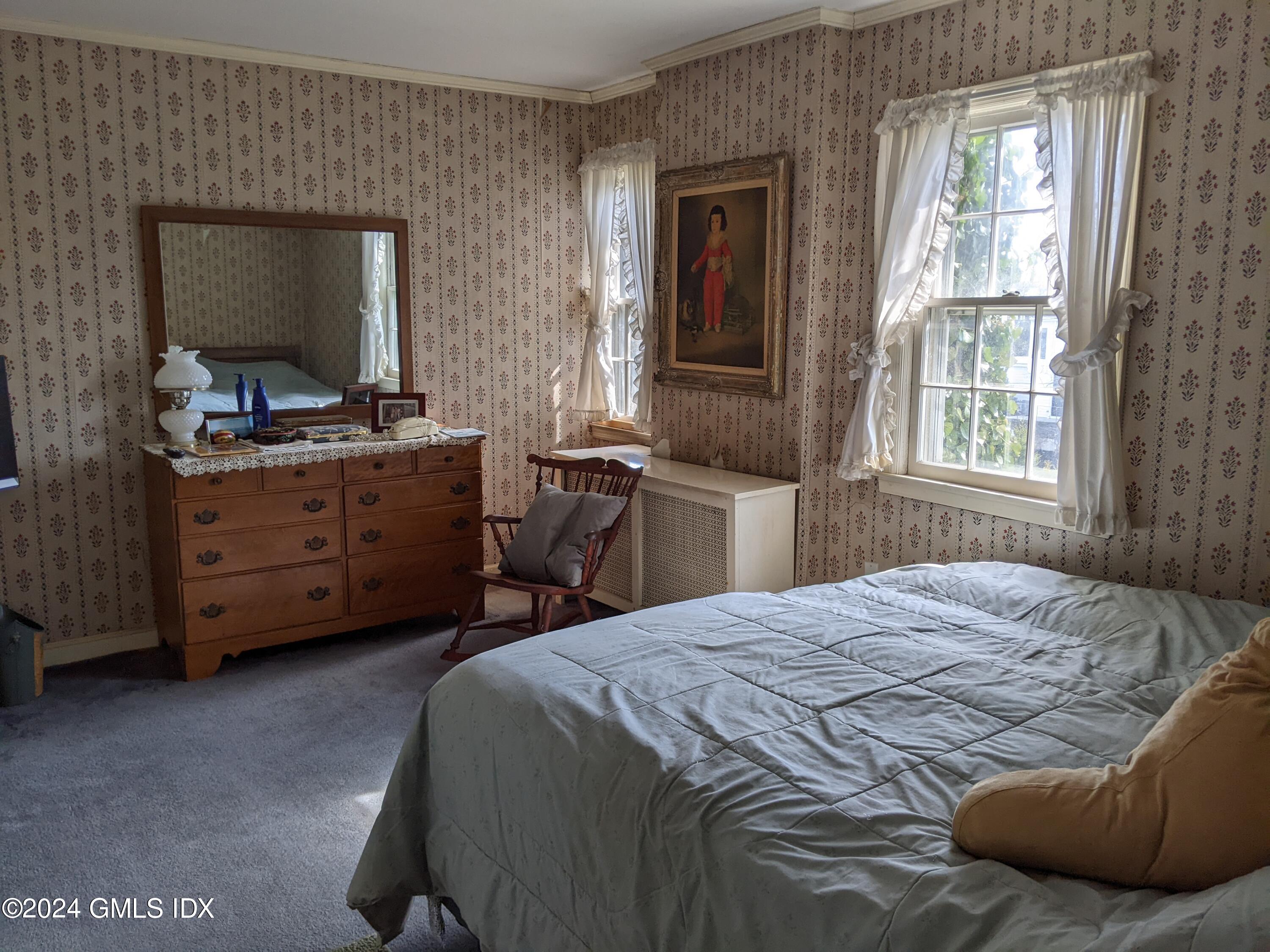 23 Ballwood Road Old Greenwich, CT 06870 - Photo 21 of 27 a bedroom with a bed and a mirror on dresser