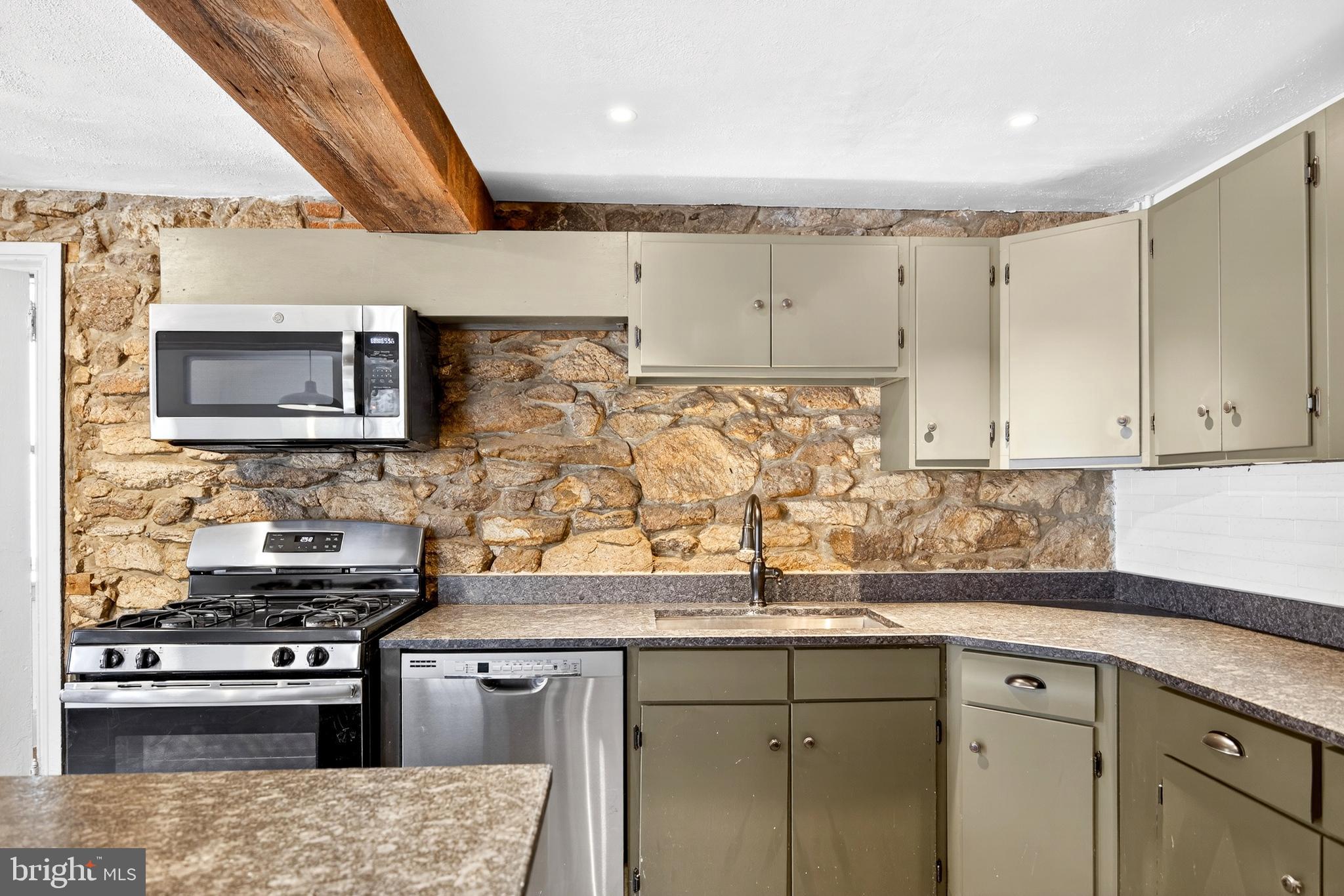 2389 Forest Grove Road Furlong, PA 18925 - Photo 11 of 20 a kitchen with stainless steel appliances granite countertop a sink stove and microwave