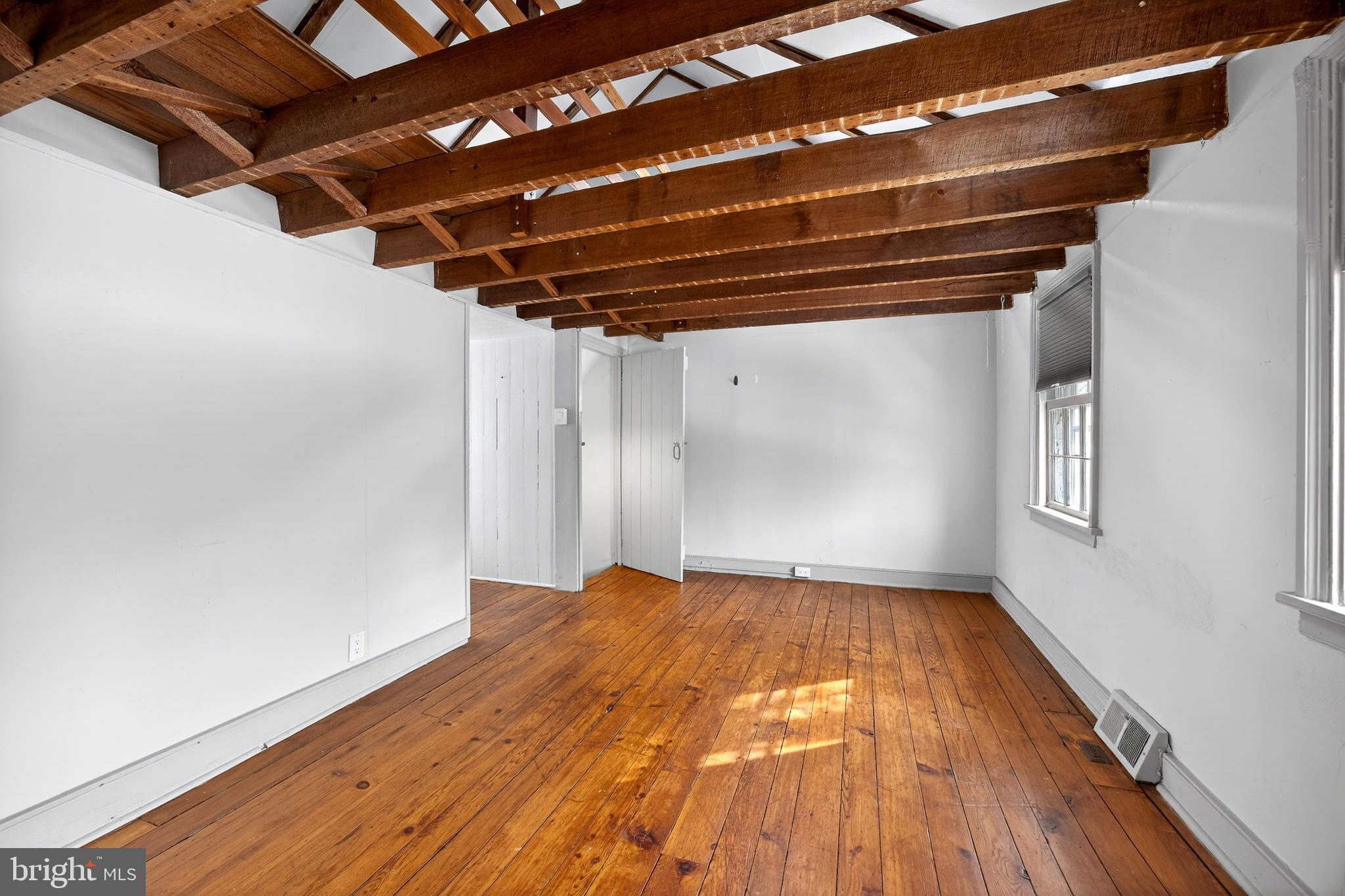2389 Forest Grove Road Furlong, PA 18925 - Photo 17 of 20 a view of an empty room with wooden floor and a window