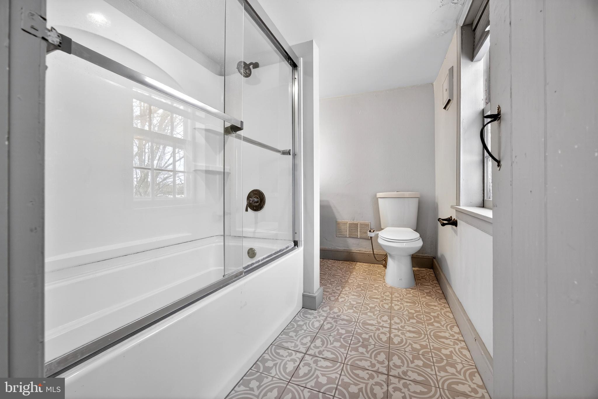 2389 Forest Grove Road Furlong, PA 18925 - Photo 18 of 20 a bathroom with a bathtub shower sink and toilet