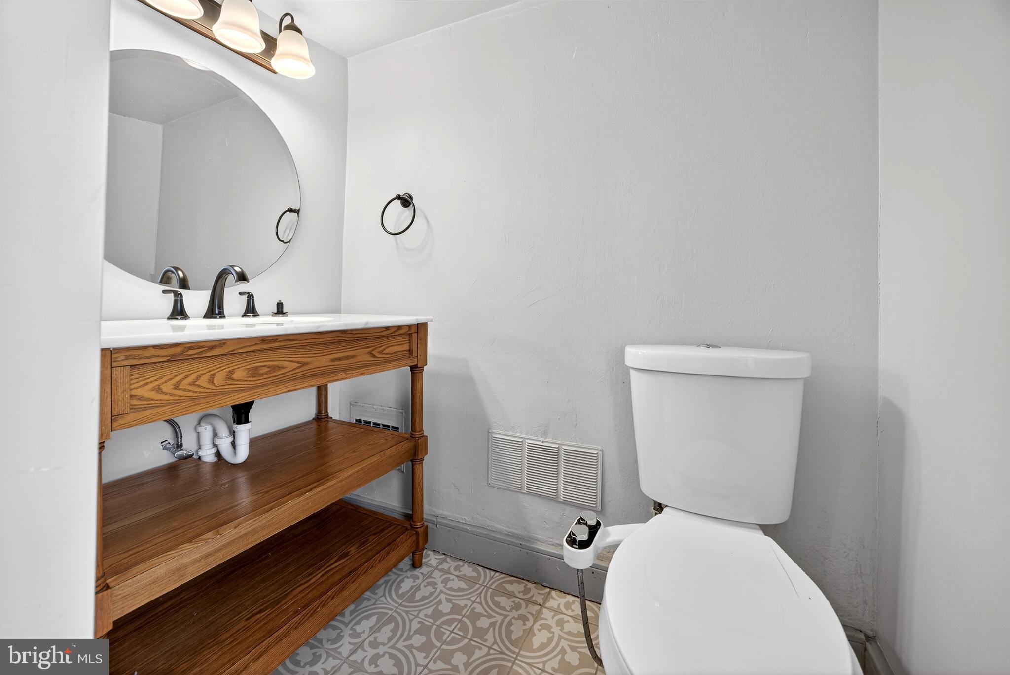 2389 Forest Grove Road Furlong, PA 18925 - Photo 19 of 20 a bathroom with a toilet a sink and mirror