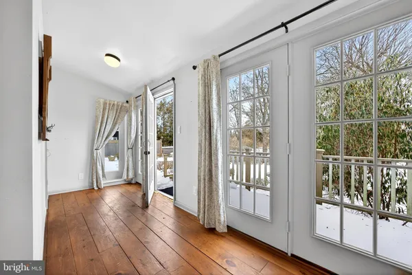 a view of entryway with wooden floor and front door