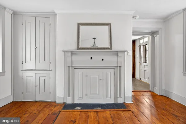 a view of a livingroom with wooden floor and cabinet