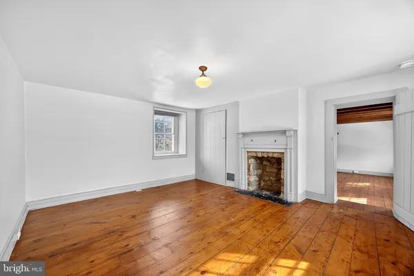 a view of empty room with a fireplace