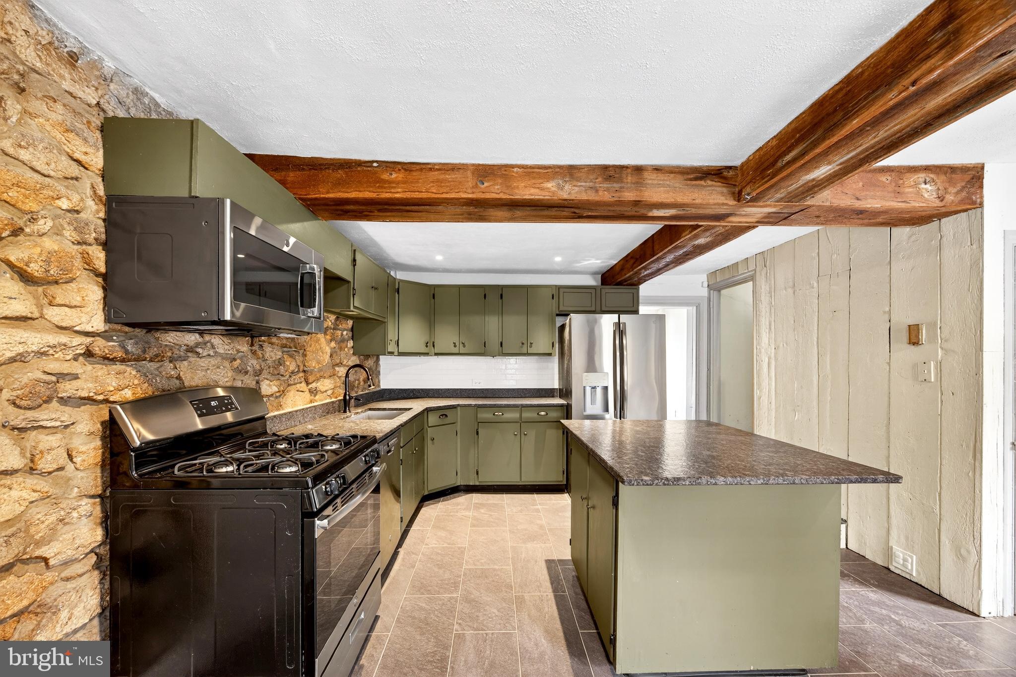 2389 Forest Grove Road Furlong, PA 18925 - Photo 10 of 20 a kitchen with granite countertop a sink and a stove top oven