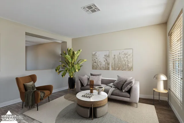 a living room with furniture and a potted plant