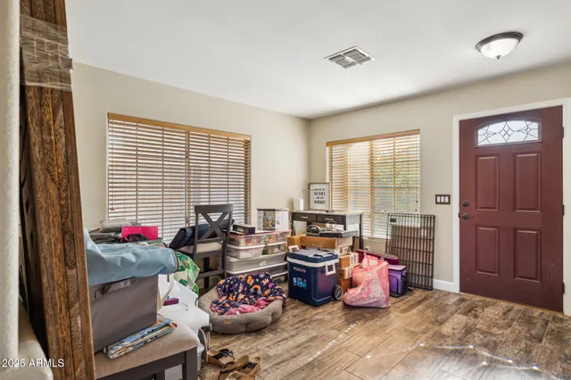 a living room filled with furniture and a large window