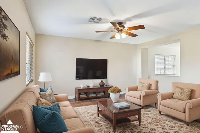 a living room with furniture and a flat screen tv