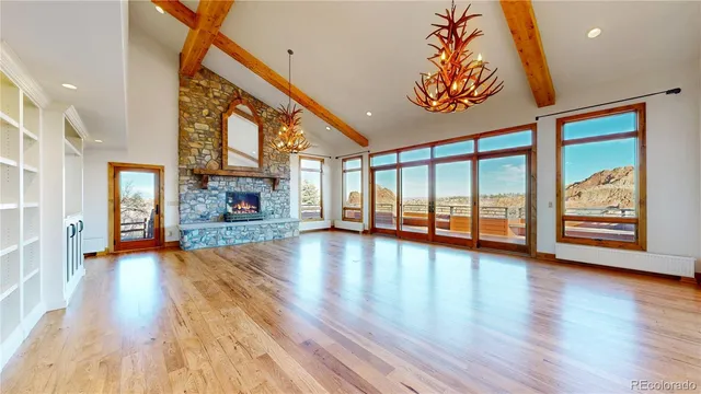 a view of an empty room with window wooden floor and front door