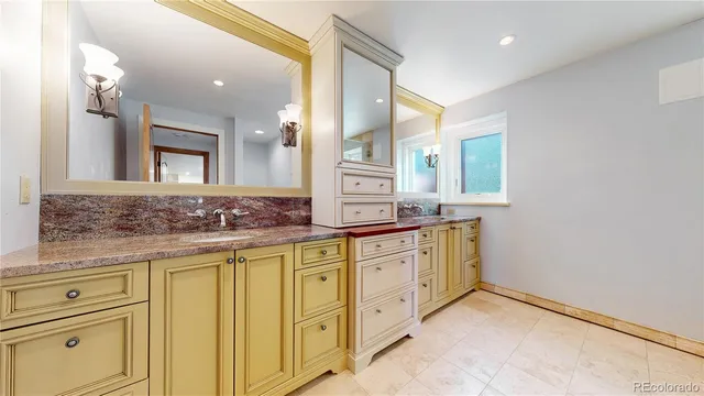 a bathroom with a granite countertop sink mirror and