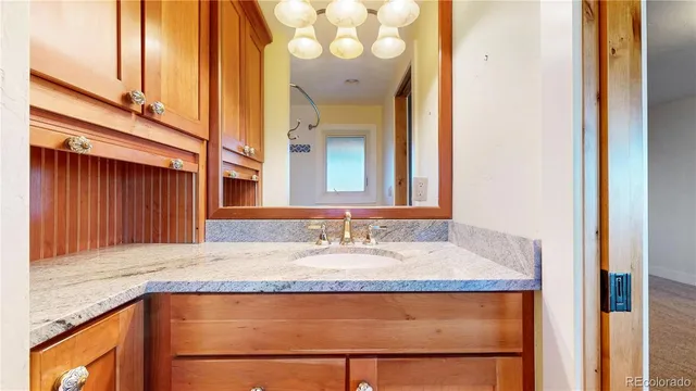 a bathroom with a tub sink and mirror