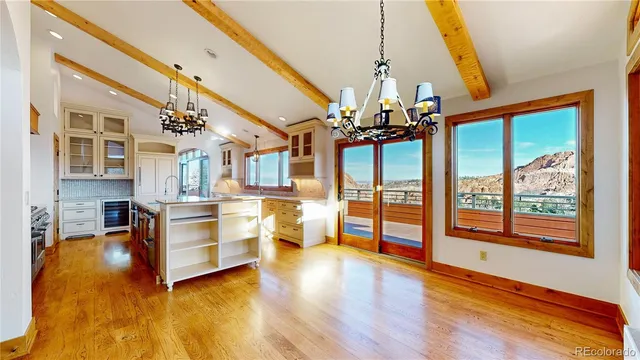 a view of a living room and kitchen with a large window