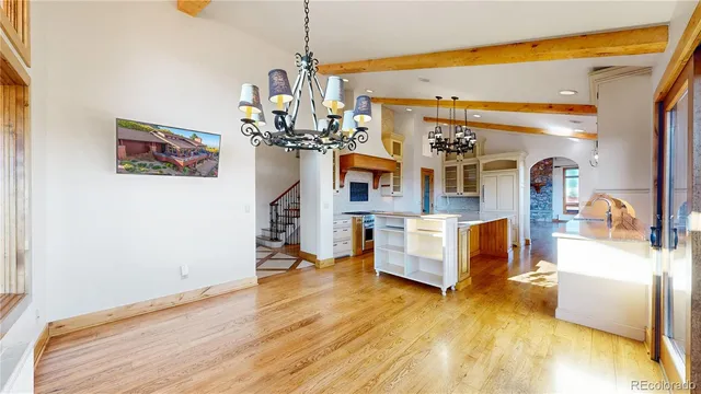 a living room with fireplace furniture and a wooden floor