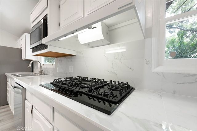 a kitchen with a stove and a sink