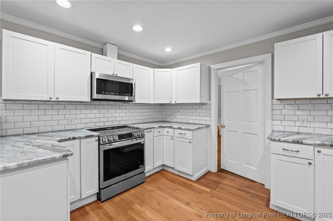 610 Maynard Lake Road Erwin, NC 28339 - Photo 29 of 49 a kitchen with a stove and a microwave