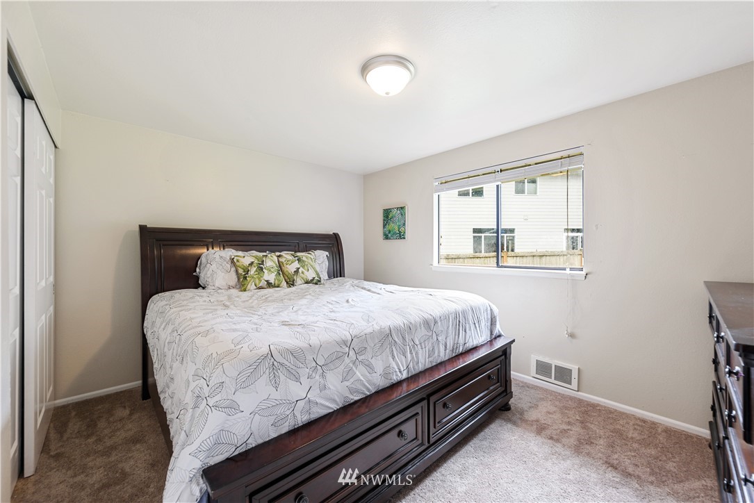 19910 Filbert Drive Bothell, WA 98012 - Photo 11 of 16 a bedroom with a bed and a window