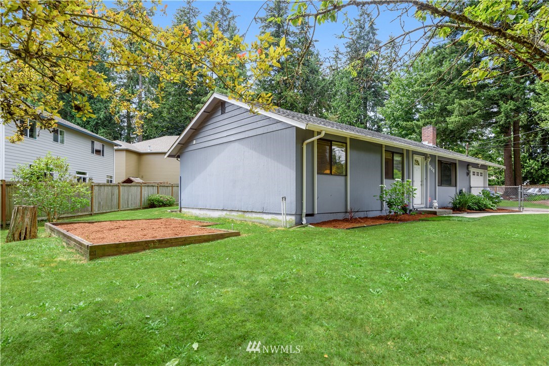 19910 Filbert Drive Bothell, WA 98012 - Photo 13 of 16 a front view of house with yard and outdoor seating