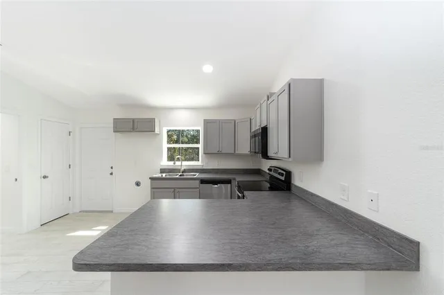a view of a living room and kitchen