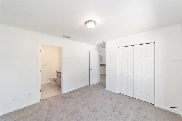 a bathroom with a granite countertop sink toilet a mirror and shower