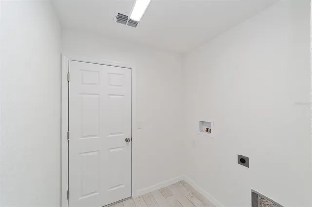 a front view of house with yard and trees in the background