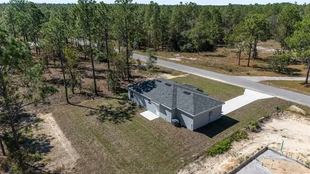 a view of a city with lush green forest