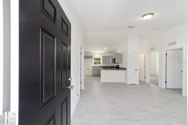 a view of kitchen with refrigerator and window